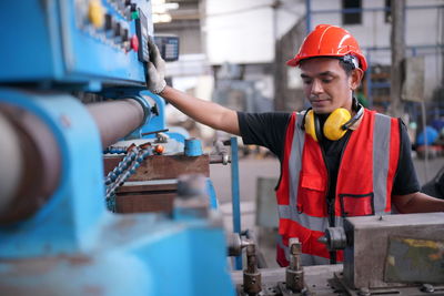 Portrait of male worker standing in the heavy industry manufacturing factory.