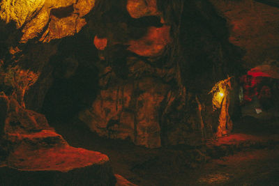 People on rock formation at night