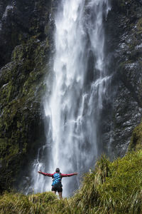 Woman in front of waterfall