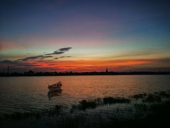 Scenic view of lake against sky during sunset