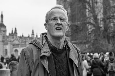 Portrait of man standing in city