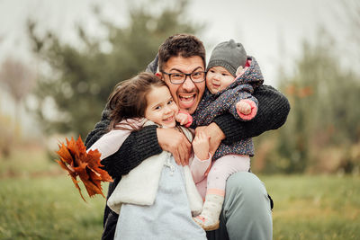 Portrait of father with kids outdoors