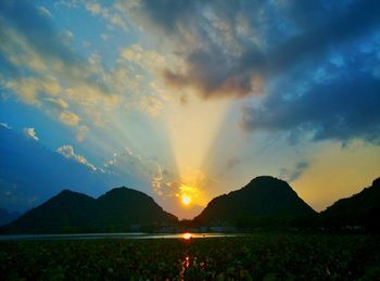 Scenic view of silhouette mountains against sky during sunset