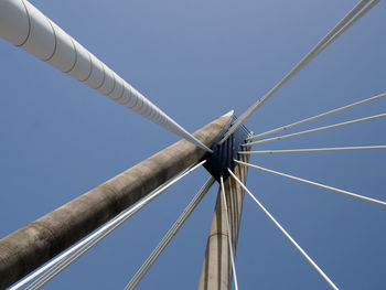 Low angle view of crane against clear blue sky