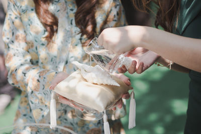 Midsection of woman holding ice cream