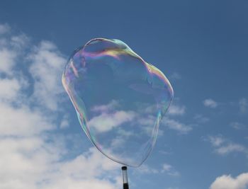 Low angle view of bubbles against sky