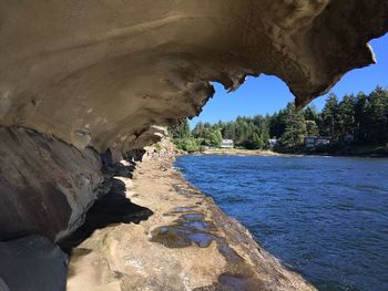 Scenic view of sea seen through cave