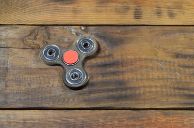 High angle view of fidget spinner on wooden table