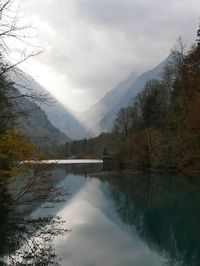 Scenic view of lake and mountains against sky