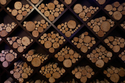 Different sizes of logs lie on a square shelves for the decoration of the restaurant