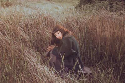 Young woman standing on field