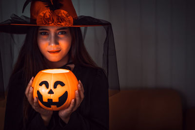 Portrait of woman with pumpkin in background