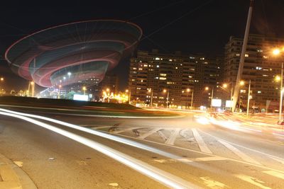 Light trails on road in city at night