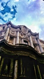 Low angle view of building against cloudy sky