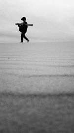 Man on beach against sky