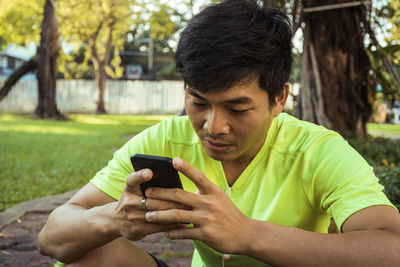 Young man using mobile phone outdoors