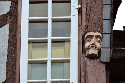 Close-up of faces wood carved in old houses in rochefort-en-terre, french brittany