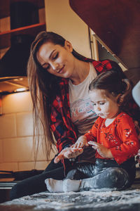 Smiling woman playing with daughter