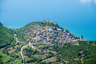 High angle view of sea and trees against sky