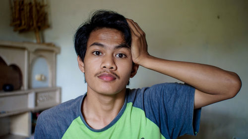 Portrait of boy against wall at home