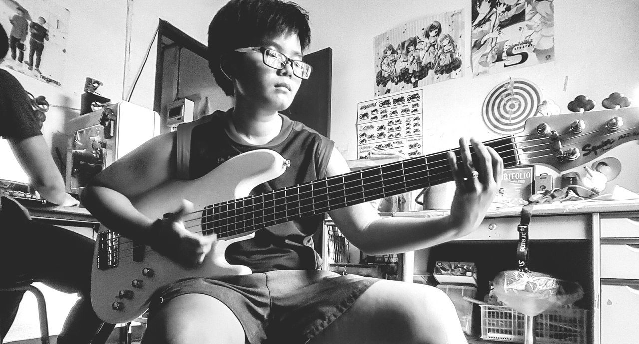 playing, guitar, leisure activity, music, boys, childhood, musical instrument, indoors, one person, real people, elementary age, plucking an instrument, arts culture and entertainment, lifestyles, day, people