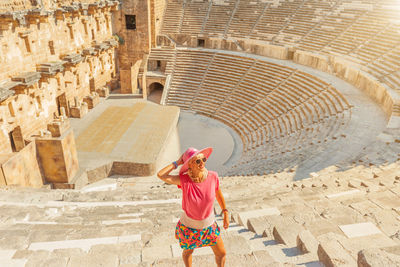 Rear view of woman walking on steps