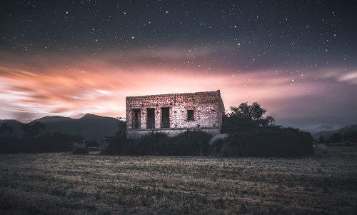 Abandoned building against sky at night