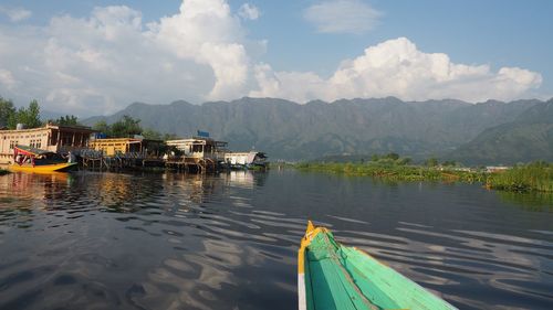 Boats moored on lake against sky