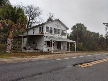 Houses by road against buildings in city