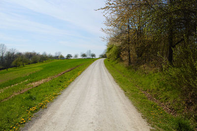 Empty road along countryside landscape