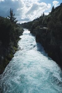 Close-up of water flowing against sky