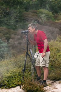 Man holding umbrella while standing on land