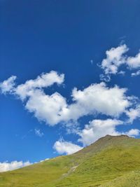 Low angle view of mountain against blue sky