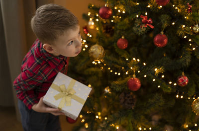 Portrait of boy decorating christmas tree