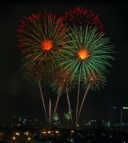 Firework display in city at night