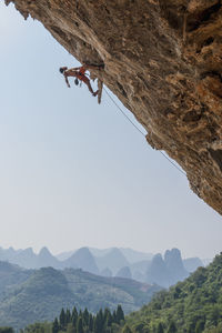 Man climbing at odin's den in yangshuo, a climbing mekka in china