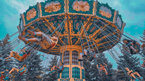 Low angle view of ferris wheel against buildings