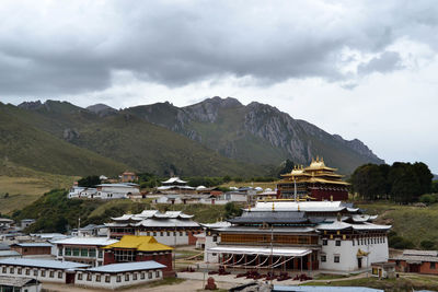 High angle view of buildings and mountains against sky