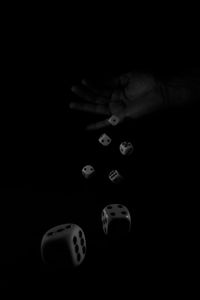 Close-up of hand over black background
