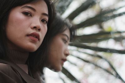 Close-up portrait of young woman looking away