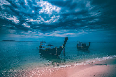 Ship moored on sea against sky