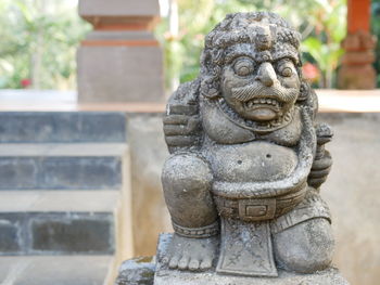 Close-up of buddha statue against temple