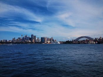 View of city by sea against sky