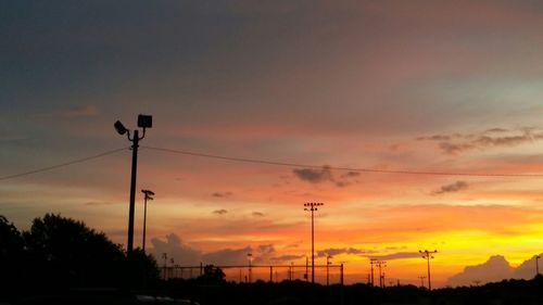 Low angle view of silhouette trees against sky at sunset