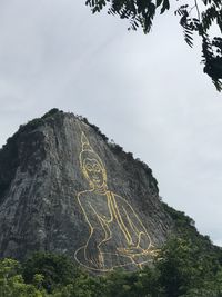 Low angle view of tree mountain against sky