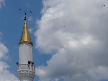 Low angle view of seagull flying against sky