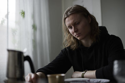 Sad woman sitting at table