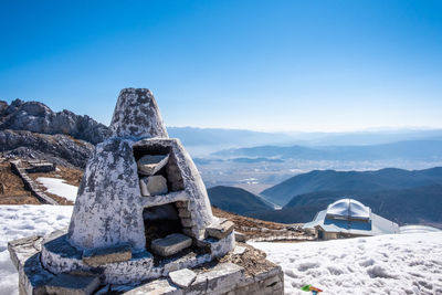 View of snowcapped mountain against blue sky