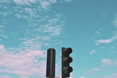 Low angle view of road signal against blue sky