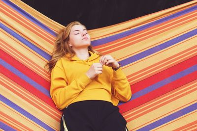 Beautiful young woman relaxing on hammock